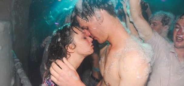 girl and guy head to head at foam party